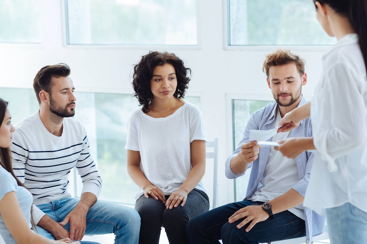 Group of people sitting together and talking.