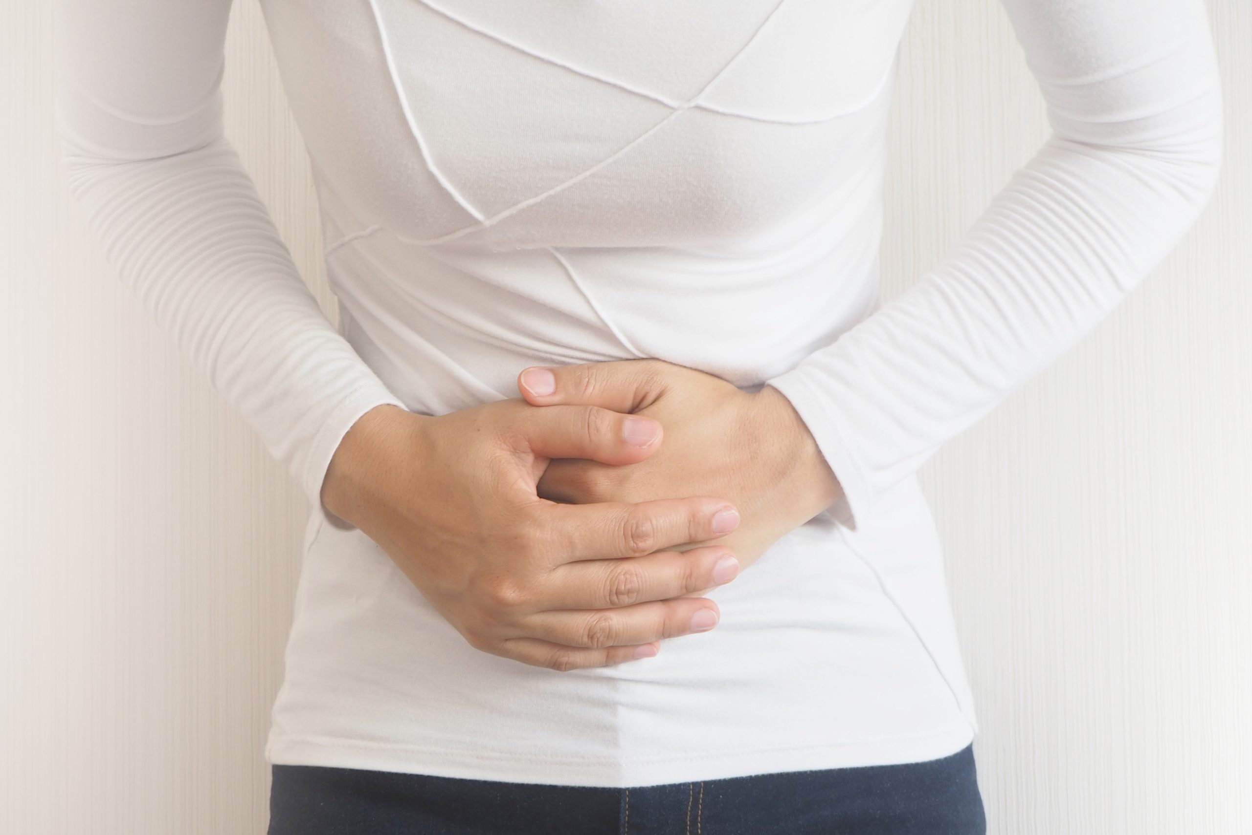 Person holding their stomach with their hands